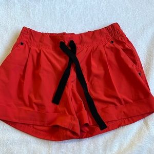 Orange Lululemon shorts. Size 4.